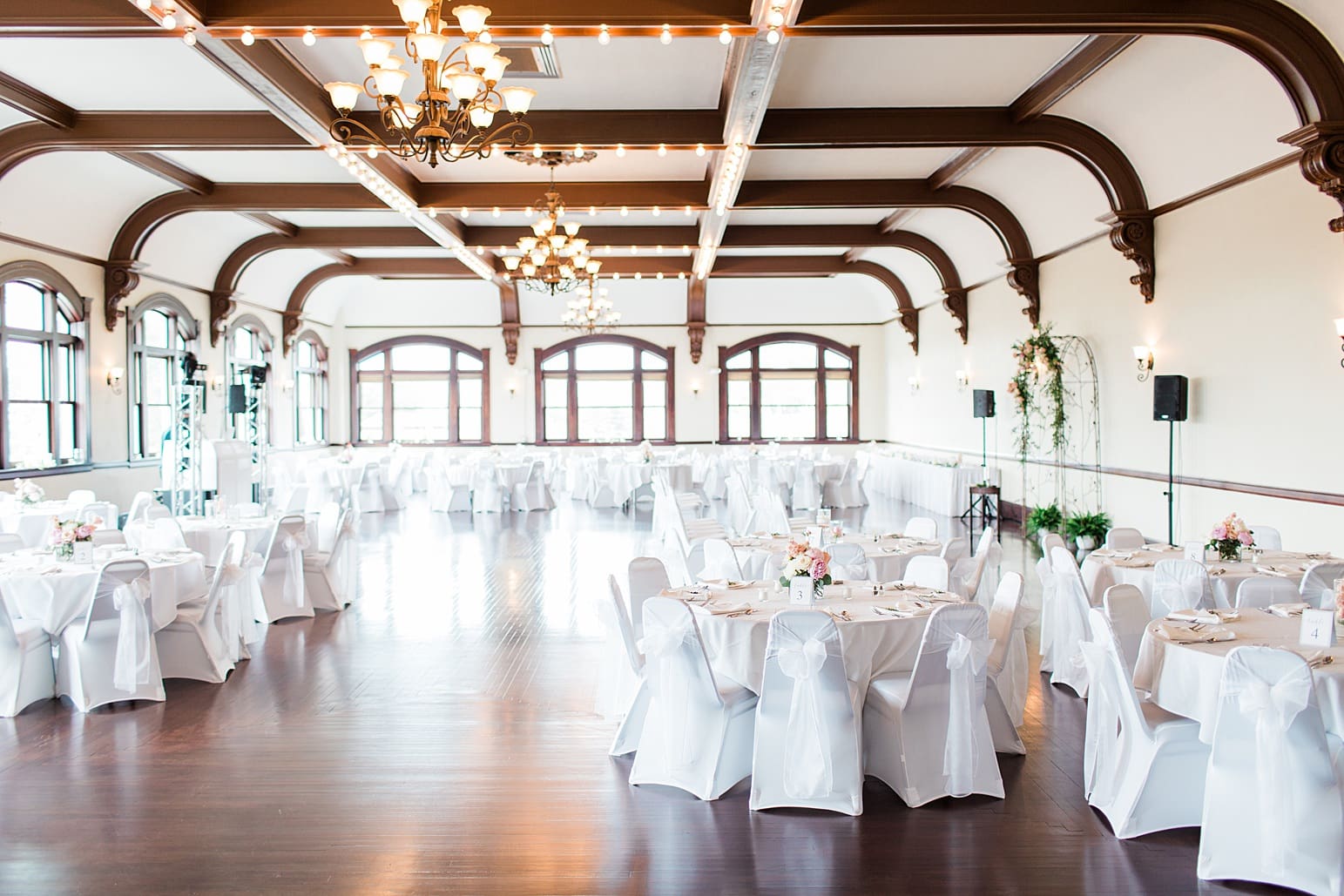Arielle Peters Photography | Wedding reception table settings and floral arrangements on wedding day at the Spohn Ballroom in Goshen, Indiana.