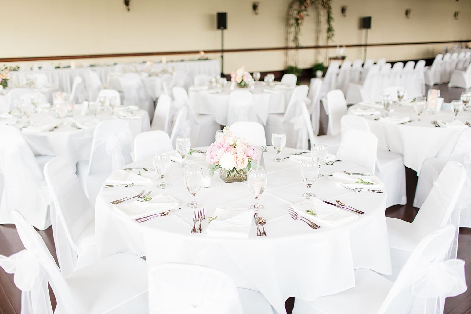 Arielle Peters Photography | Wedding reception table settings and floral arrangements on wedding day at the Spohn Ballroom in Goshen, Indiana.