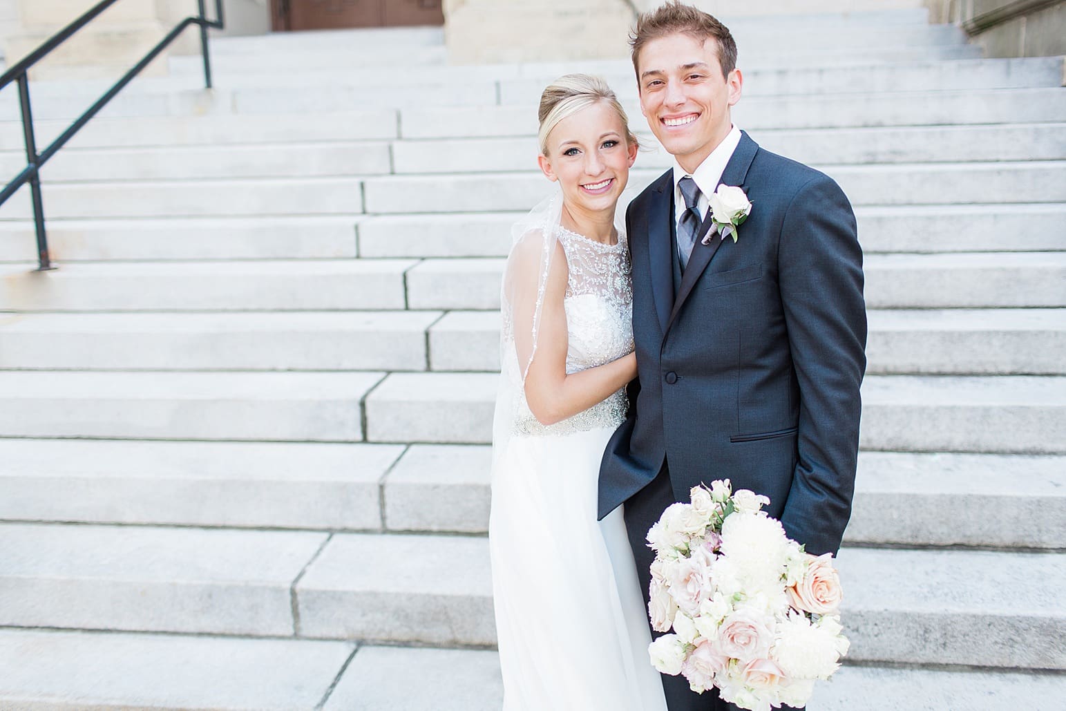 Arielle Peters Photography | Bride and groom standing on church steps on wedding day at the Spohn Ballroom in Goshen, Indiana.