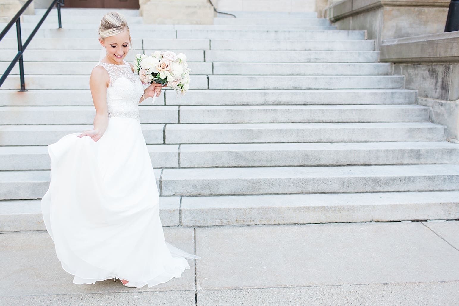 Arielle Peters Photography | Bride dancing on church steps on wedding day at the Spohn Ballroom in Goshen, Indiana.