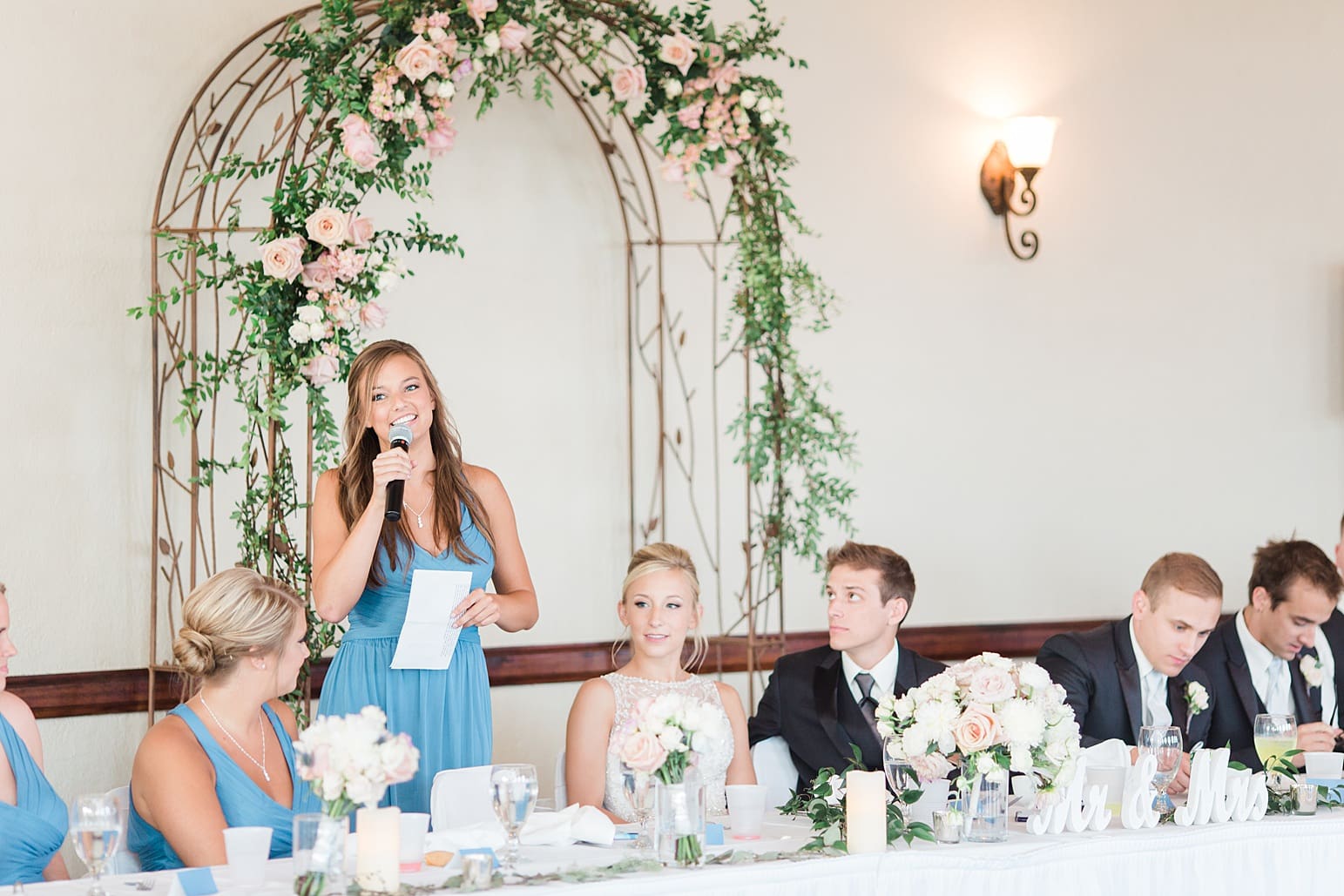 Arielle Peters Photography | Maid of honor giving speech at wedding reception on wedding day at the Spohn Ballroom in Goshen, Indiana.