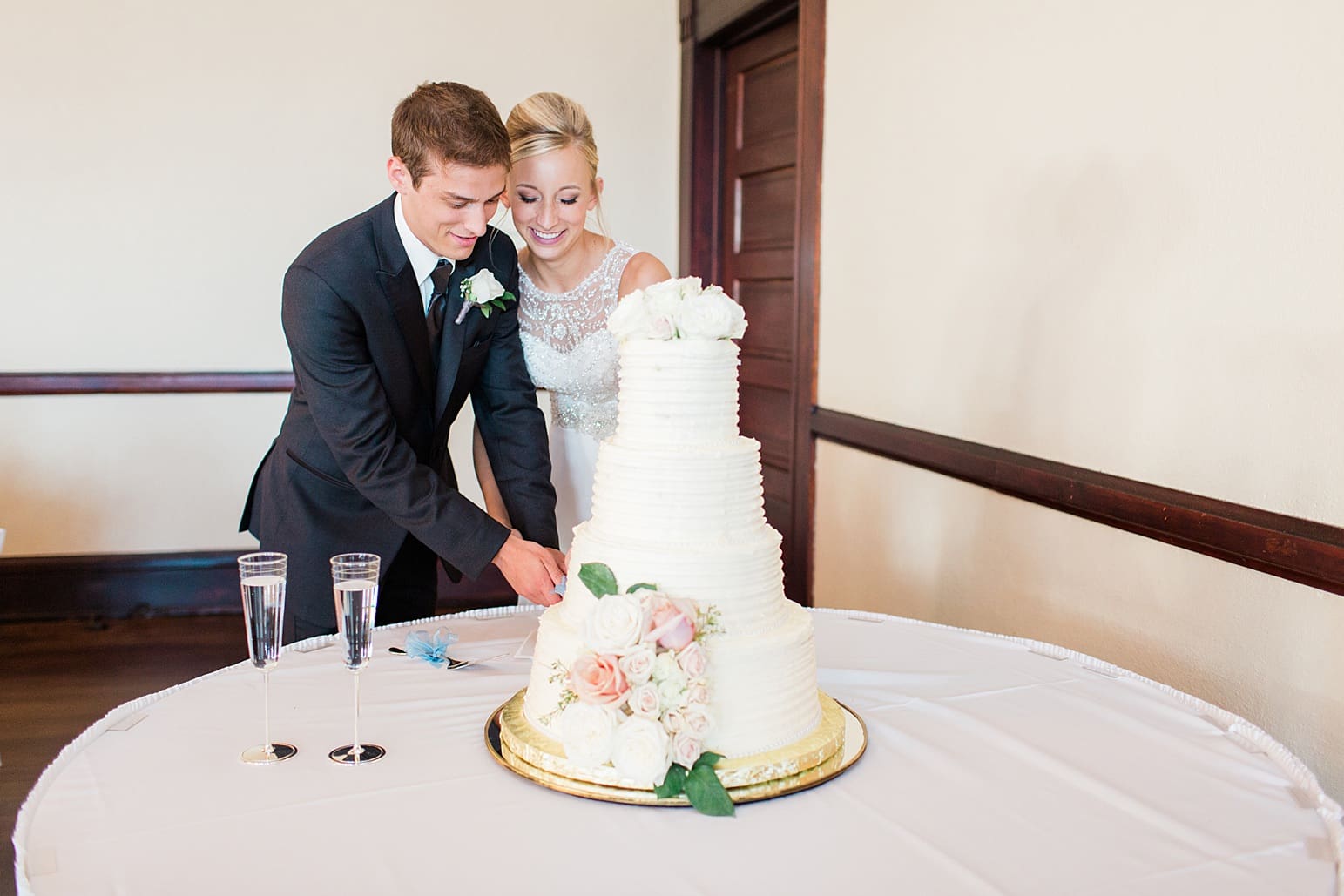 Arielle Peters Photography | Bride and groom cutting wedding cake at wedding reception on wedding day at the Spohn Ballroom in Goshen, Indiana.