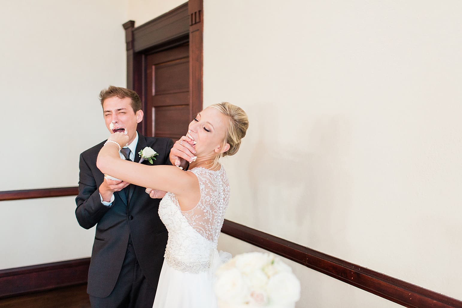 Arielle Peters Photography | Bride and groom eating wedding cake at wedding reception on wedding day at the Spohn Ballroom in Goshen, Indiana.