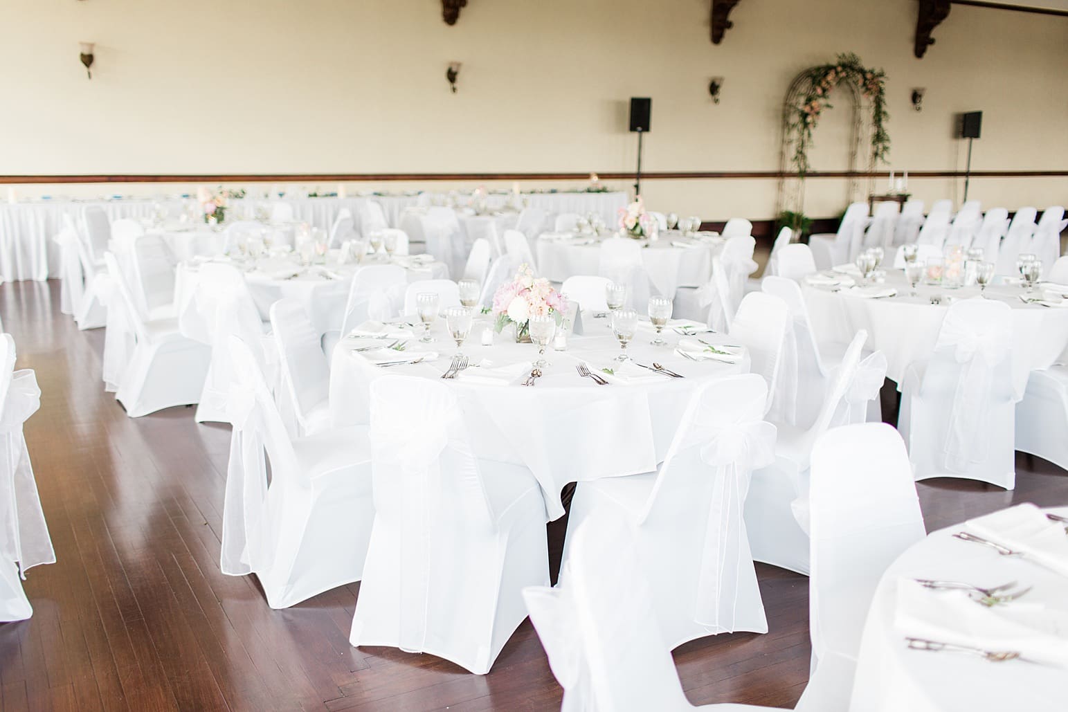 Arielle Peters Photography | Wedding reception table settings and floral arrangements on wedding day at the Spohn Ballroom in Goshen, Indiana.