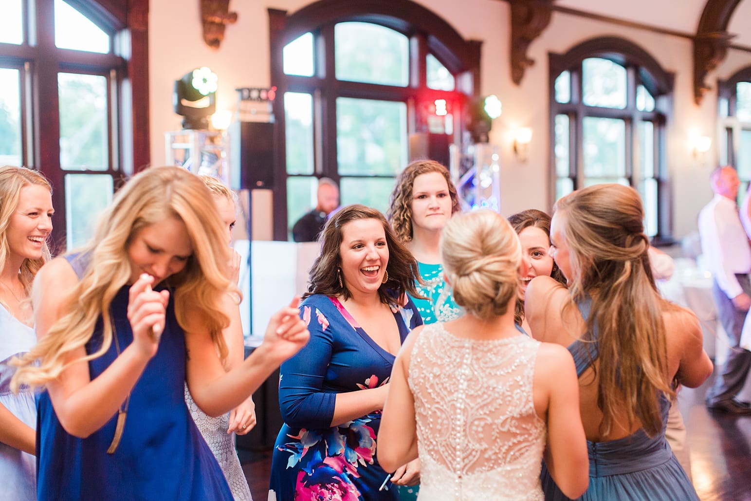 Arielle Peters Photography | Bride and groom dancing with guests at wedding reception on wedding day at the Spohn Ballroom in Goshen, Indiana.