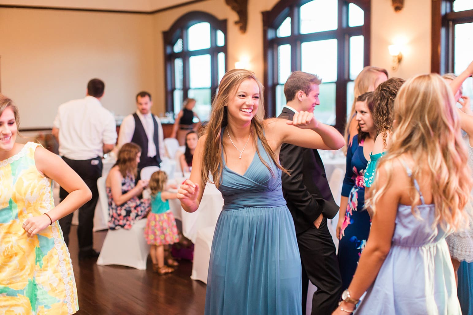 Arielle Peters Photography | Bride and groom dancing with guests at wedding reception on wedding day at the Spohn Ballroom in Goshen, Indiana.