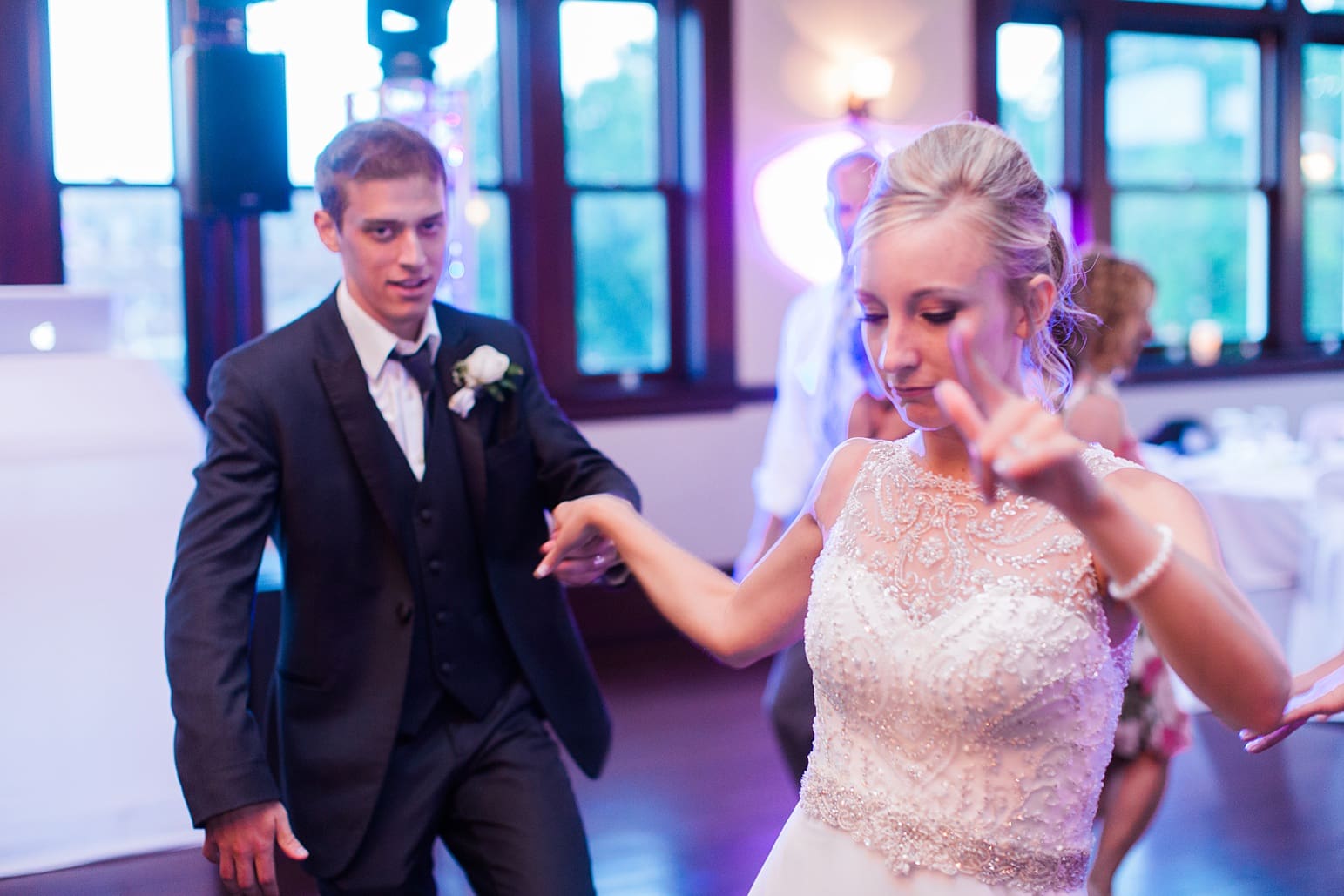 Arielle Peters Photography | Bride and groom dancing with guests at wedding reception on wedding day at the Spohn Ballroom in Goshen, Indiana.