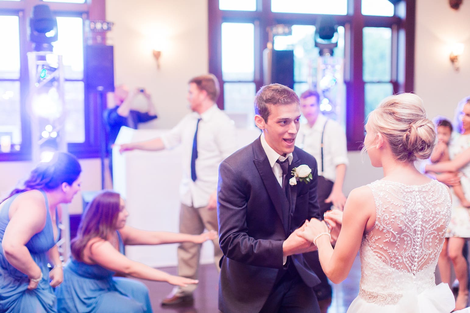 Arielle Peters Photography | Bride and groom dancing with guests at wedding reception on wedding day at the Spohn Ballroom in Goshen, Indiana.