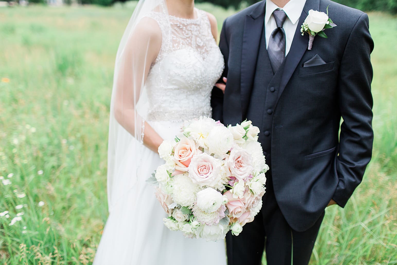 Arielle Peters Photography | Bride and groom walking in open field on wedding day at the Spohn Ballroom in Goshen, Indiana.