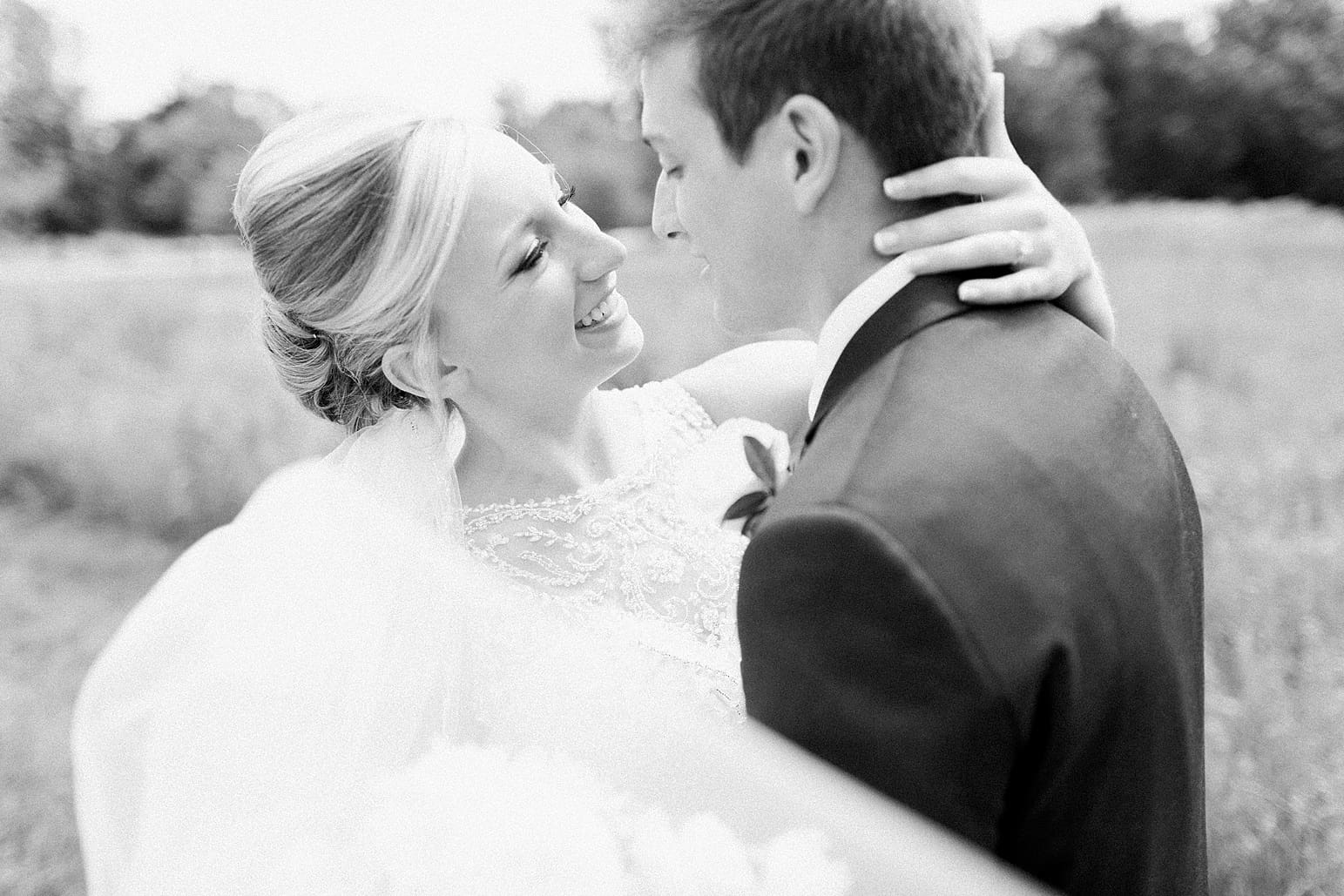Arielle Peters Photography | Bride and groom in open field on wedding day at the Spohn Ballroom in Goshen, Indiana.
