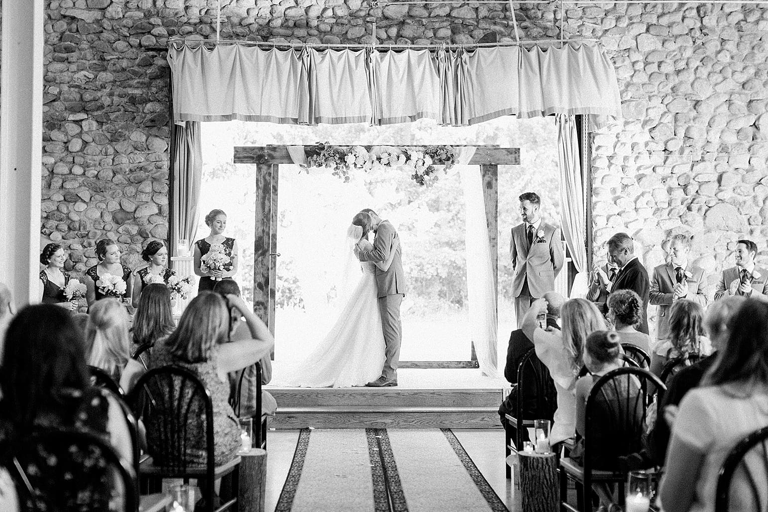 Arielle Peters Photography | Bride and groom kissing at the alter on wedding day at Lawton Lions Heritage Community Center in Lawton, Michigan.