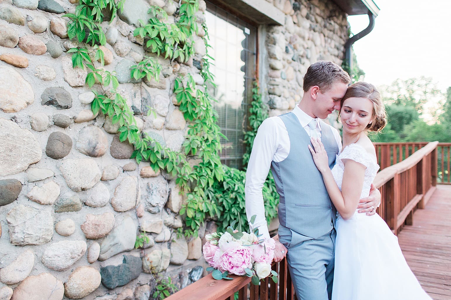 Arielle Peters Photography | Bride and groom on wooden terrace on wedding day at Lawton Lions Heritage Community Center in Lawton, Michigan.