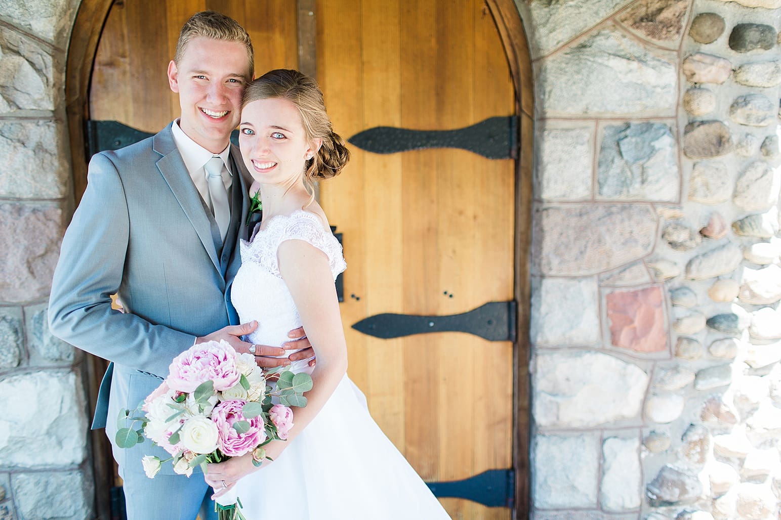 Arielle Peters Photography | Bride and groom in front of wooden cellar door on wedding day at Lawton Lions Heritage Community Center in Lawton, Michigan.