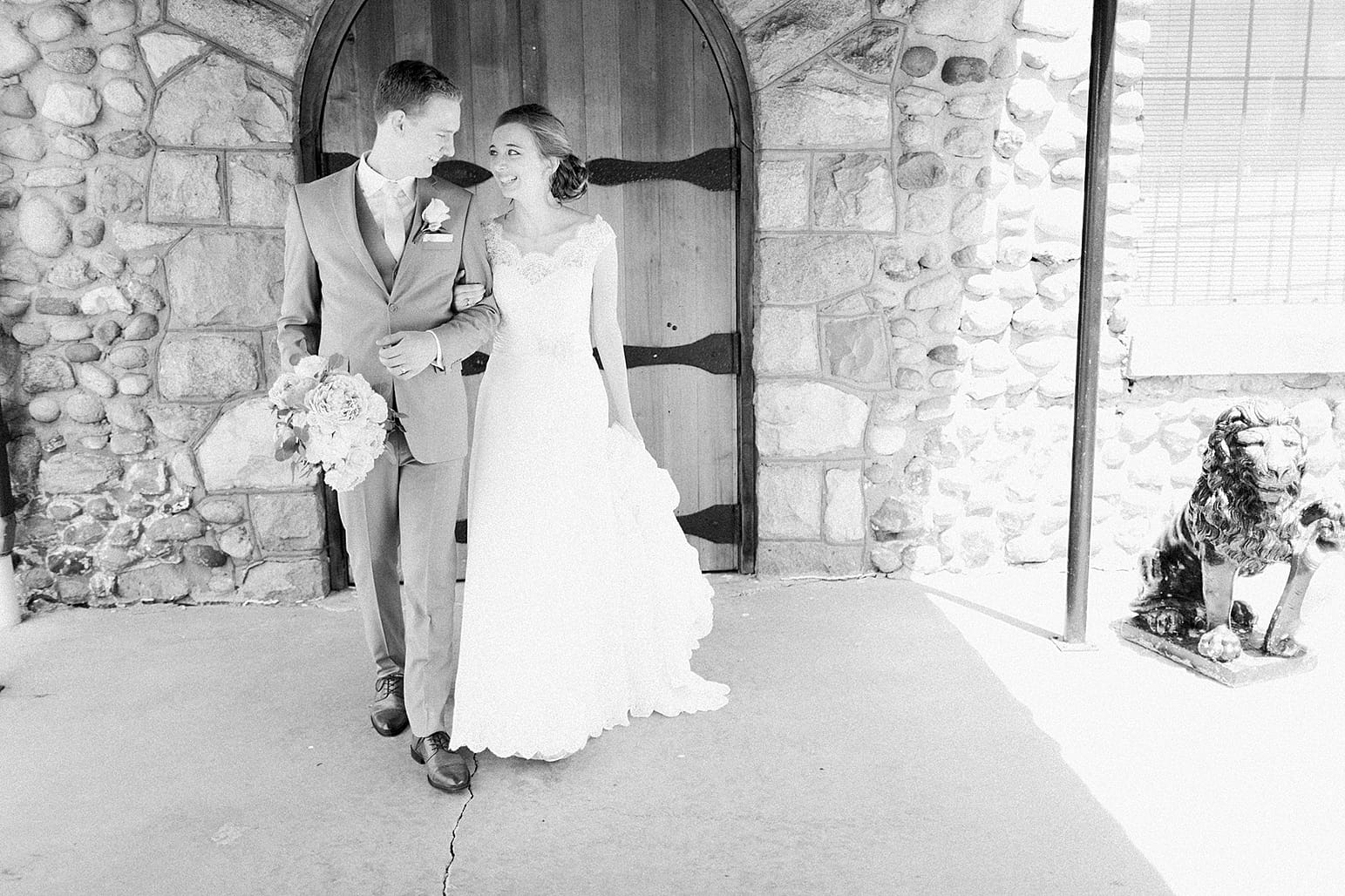 Arielle Peters Photography | Bride and groom in front of wooden cellar door on wedding day at Lawton Lions Heritage Community Center in Lawton, Michigan.