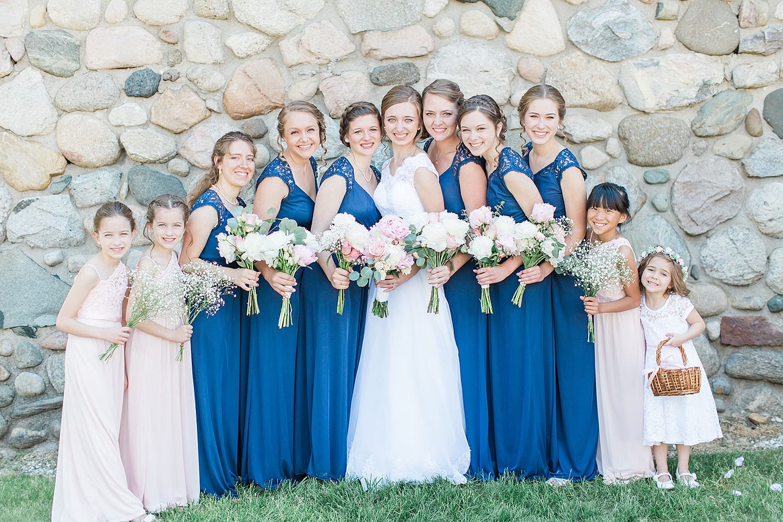 Arielle Peters Photography | Bride and bridesmaids by historic cobblestone building on wedding day at Lawton Lions Heritage Community Center in Lawton, Michigan.