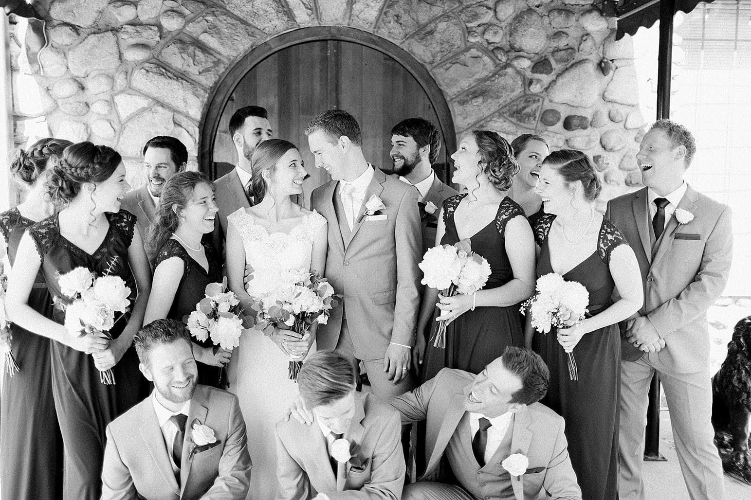 Arielle Peters Photography | Wedding party by wooden cellar door on wedding day at Lawton Lions Heritage Community Center in Lawton, Michigan.