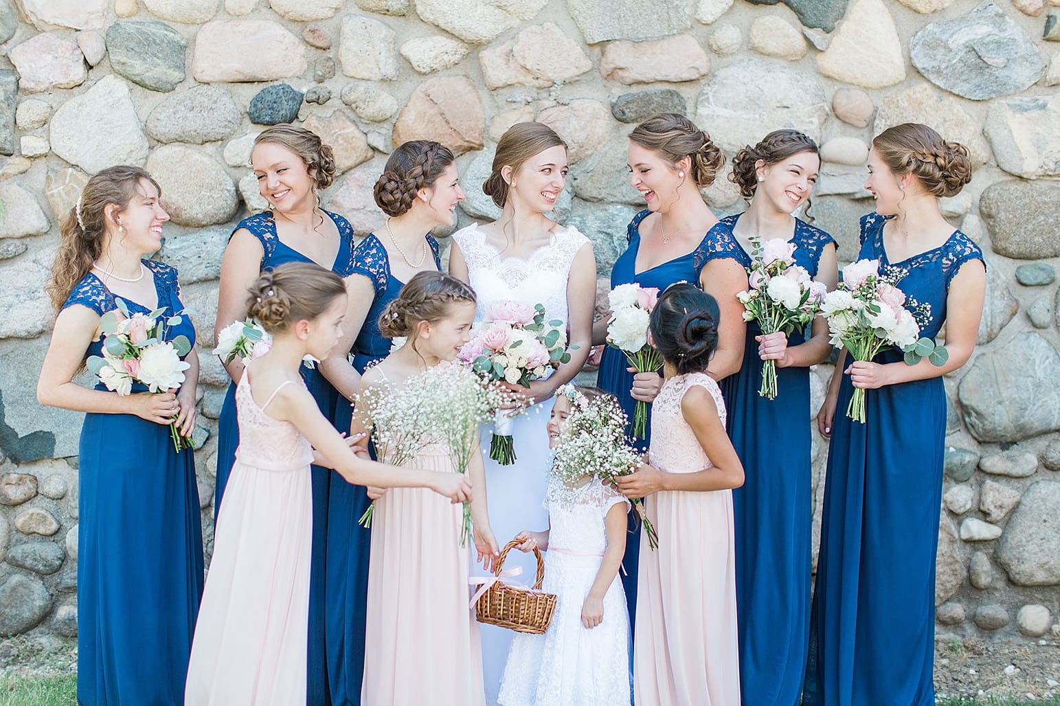 Arielle Peters Photography | Bride and bridesmaids next to historic cobblestone building on wedding day at Lawton Lions Heritage Community Center in Lawton, Michigan.
