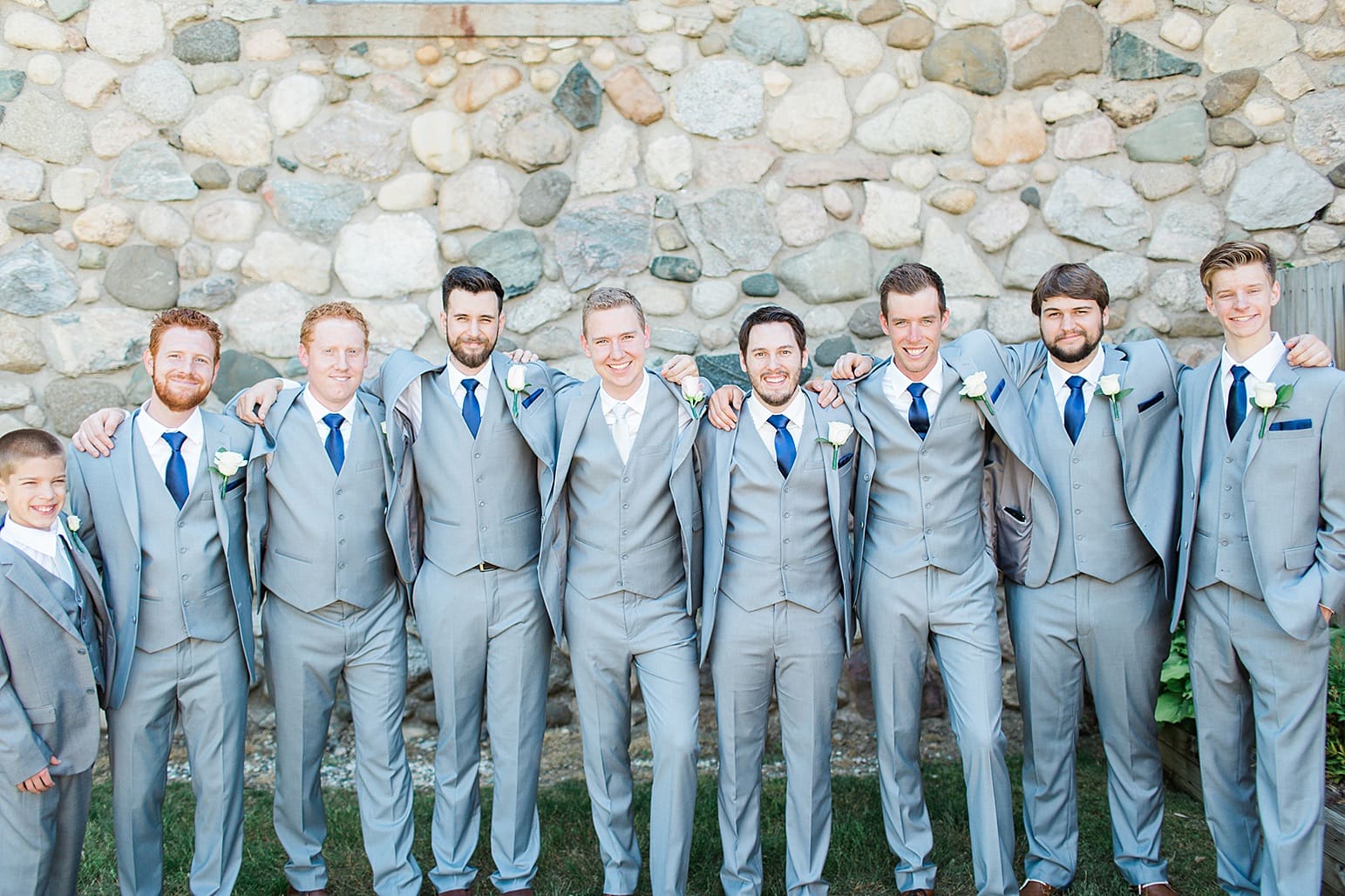 Arielle Peters Photography | Groom and groomsmen next to historic cobblestone building on wedding day at Lawton Lions Heritage Community Center in Lawton, Michigan.