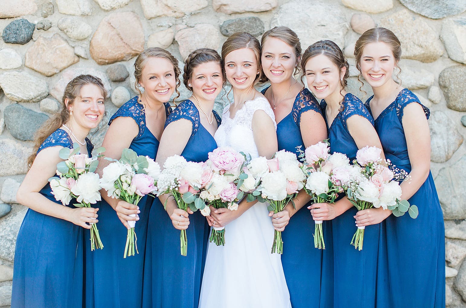 Arielle Peters Photography | Bride and bridesmaids next to historic cobblestone building on wedding day at Lawton Lions Heritage Community Center in Lawton, Michigan.