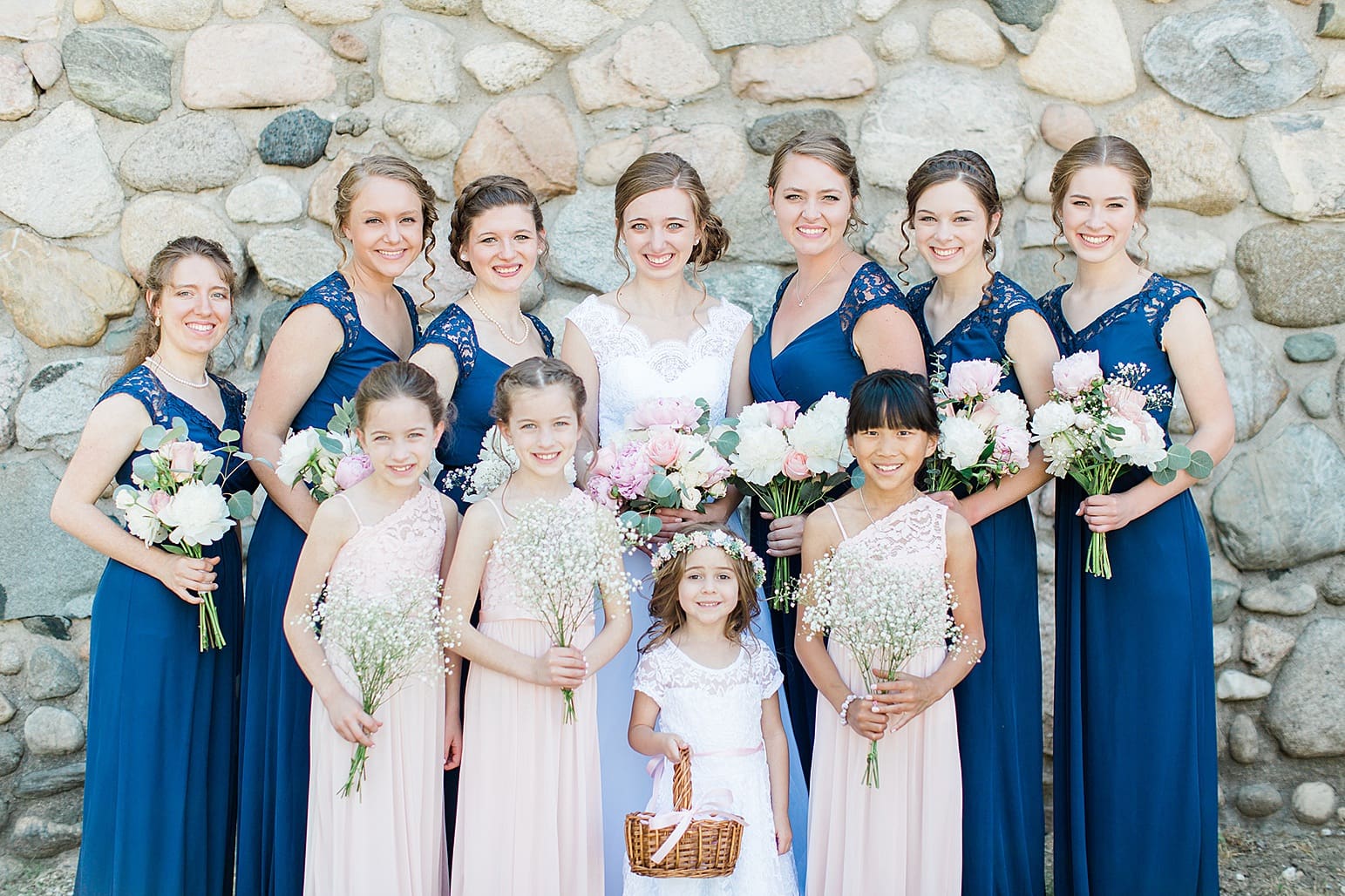 Arielle Peters Photography | Bride and bridesmaids next to historic cobblestone building on wedding day at Lawton Lions Heritage Community Center in Lawton, Michigan.