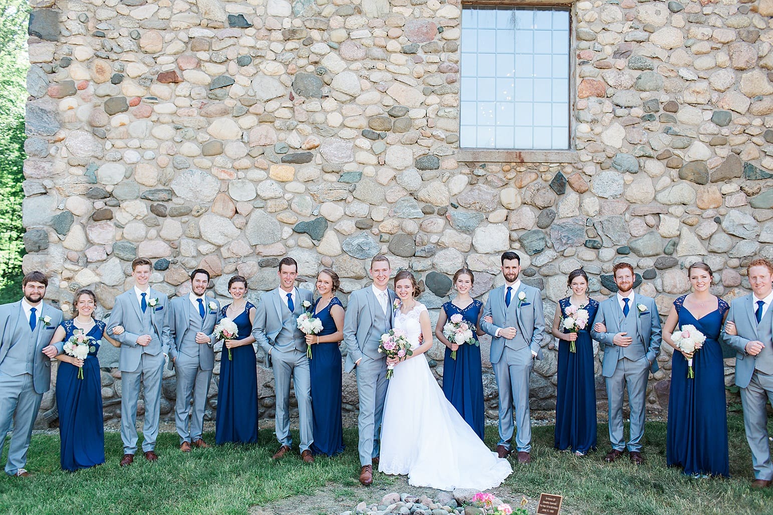 Arielle Peters Photography | Wedding party next to historic cobblestone building on wedding day at Lawton Lions Heritage Community Center in Lawton, Michigan.