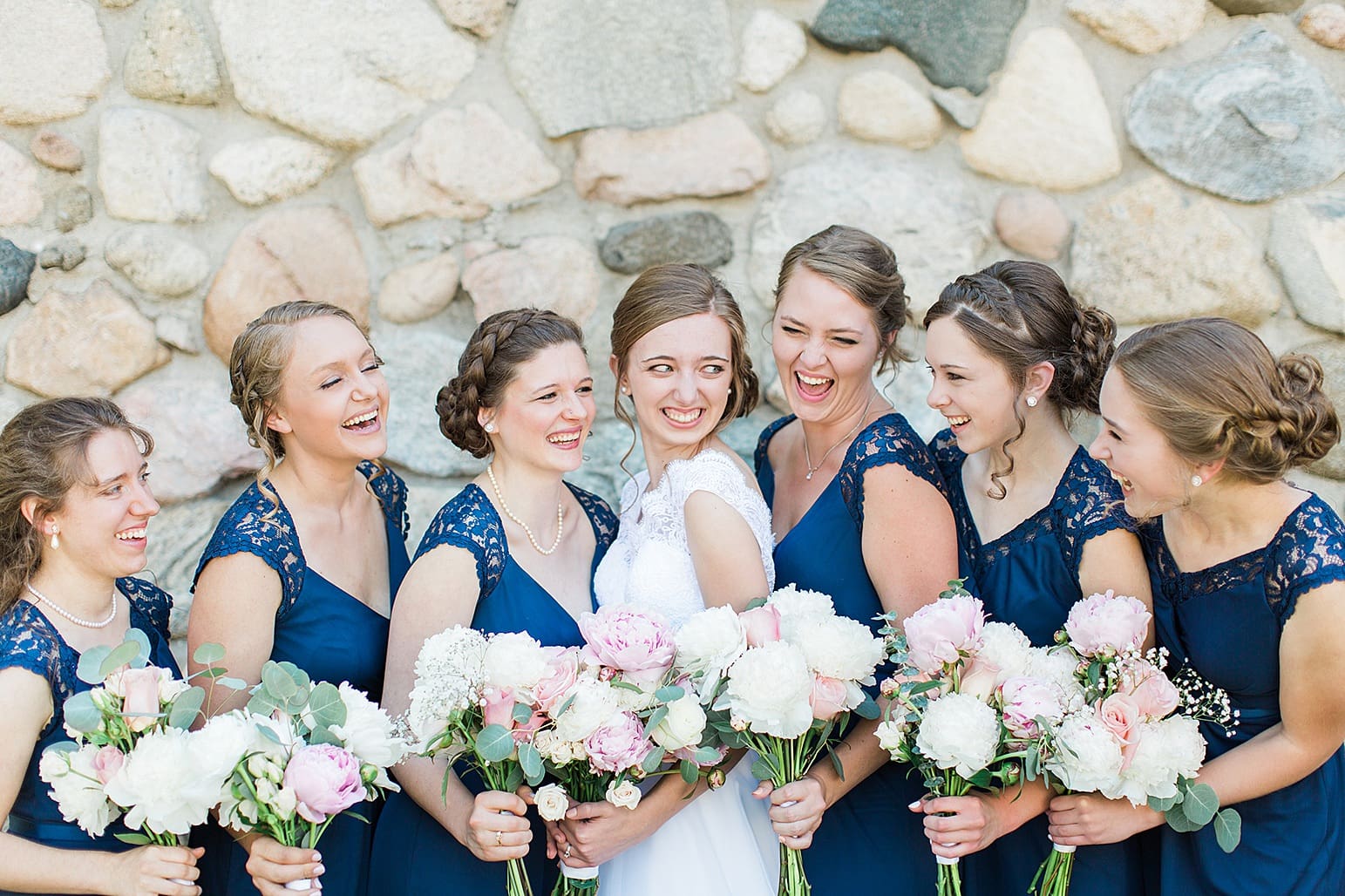 Arielle Peters Photography | Bride and bridesmaids next to historic cobblestone building on wedding day at Lawton Lions Heritage Community Center in Lawton, Michigan.