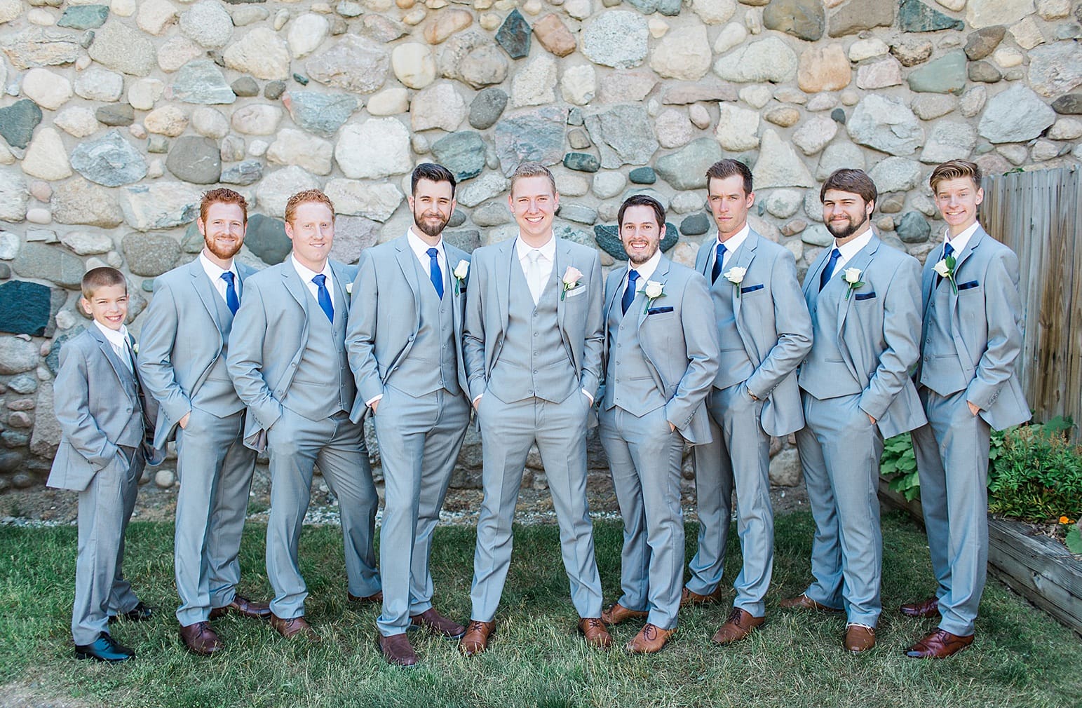 Arielle Peters Photography | Groom and groomsmen next to historic cobblestone building on wedding day at Lawton Lions Heritage Community Center in Lawton, Michigan.
