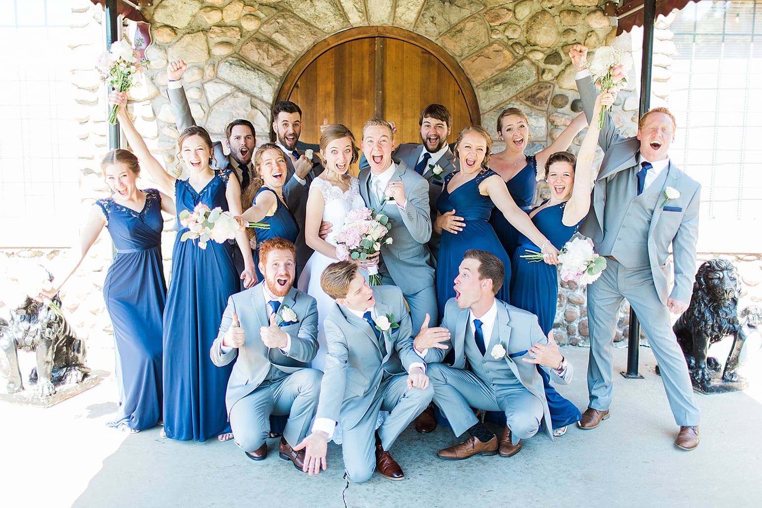 Arielle Peters Photography | Wedding party cheering in front of wooden cellar door on wedding day at Lawton Lions Heritage Community Center in Lawton, Michigan.