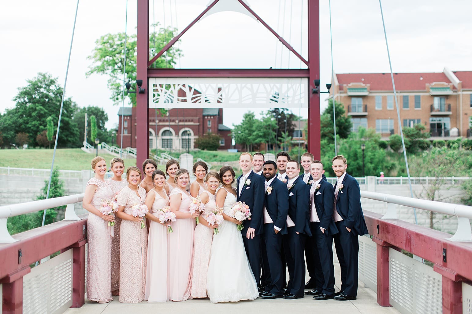 Arielle Peters Photography | Wedding party standing on suspension bridge on wedding day at First United Methodist Church in Mishawaka, Indiana.