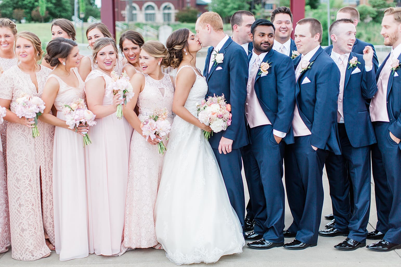 Arielle Peters Photography | Bride and groom kissing on suspension bridge on wedding day at First United Methodist Church in Mishawaka, Indiana.