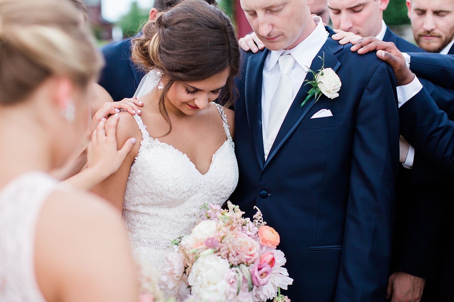Arielle Peters Photography | Wedding party praying over bride and groom on wedding day at First United Methodist Church in Mishawaka, Indiana.