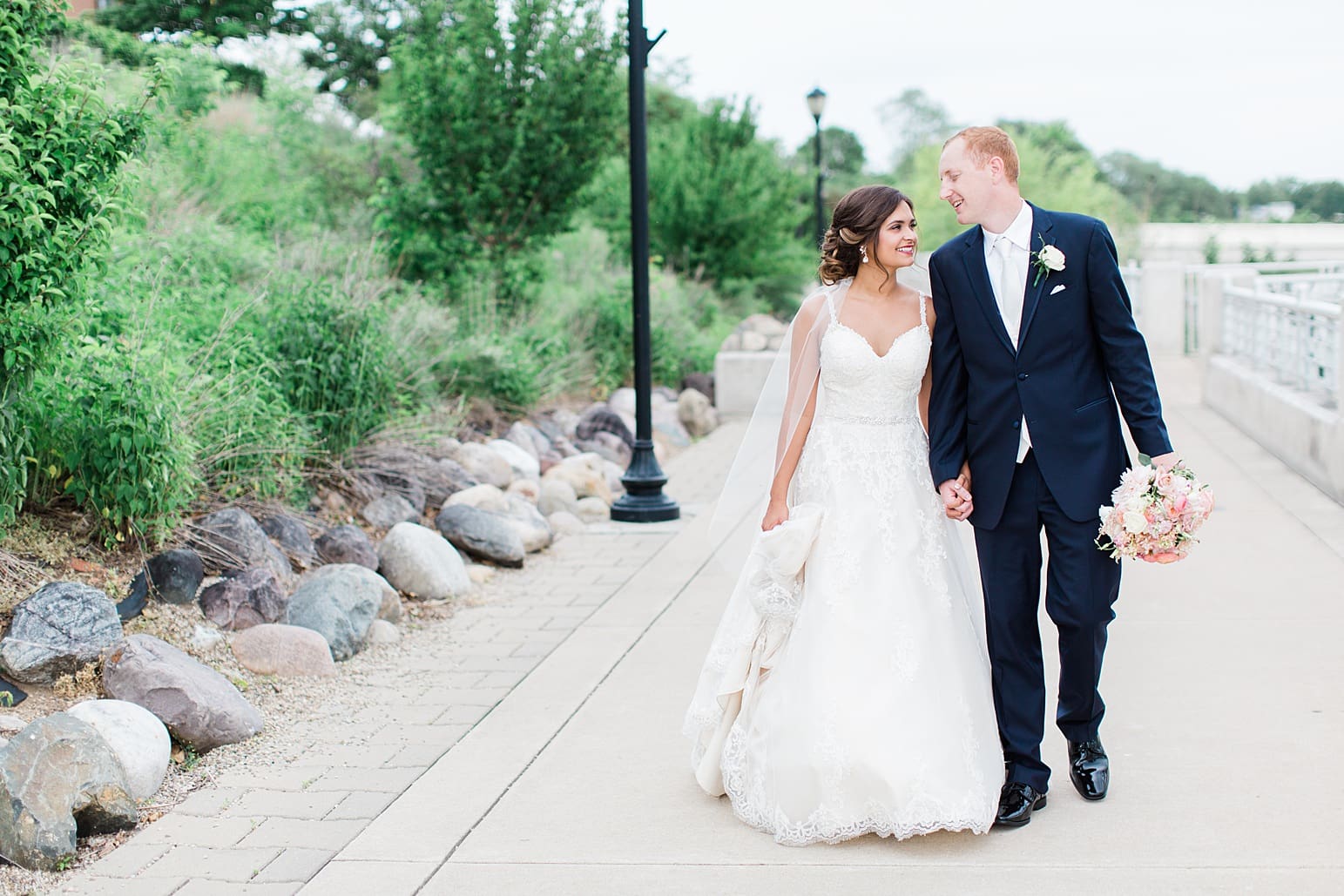 Arielle Peters Photography | Bride and groom walking next to lake on wedding day at First United Methodist Church in Mishawaka, Indiana.