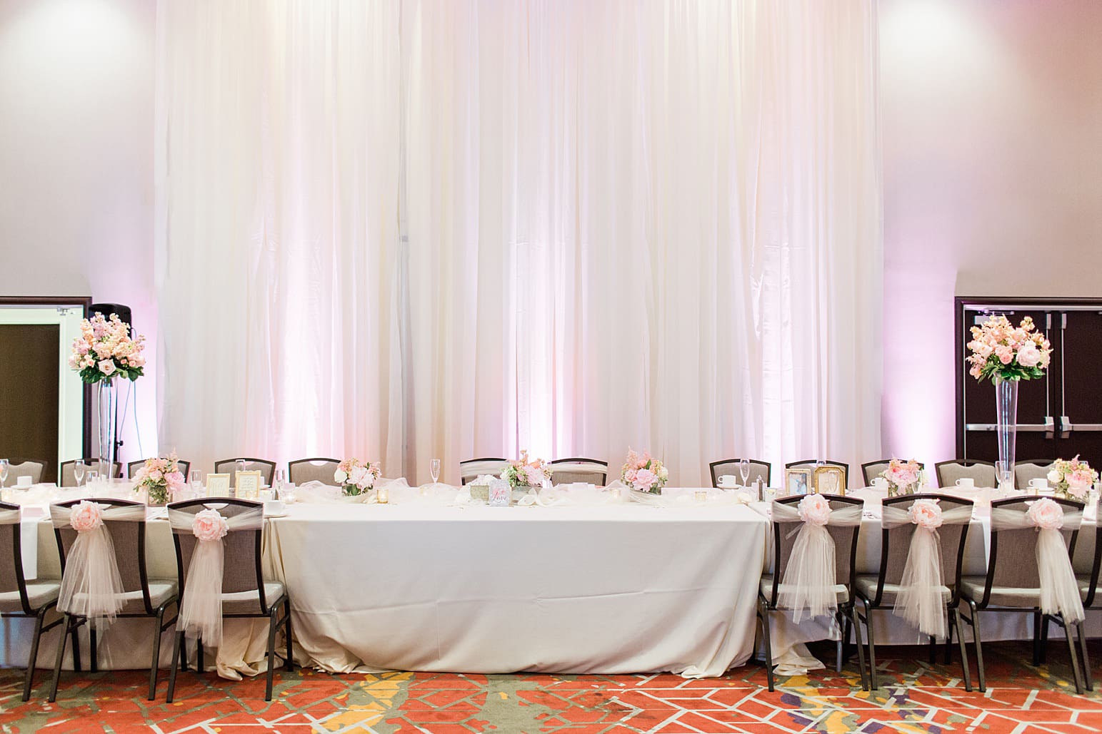 Arielle Peters Photography | Wedding reception head table settings and floral arrangements at the Holiday Inn in Mishawaka, Indiana.