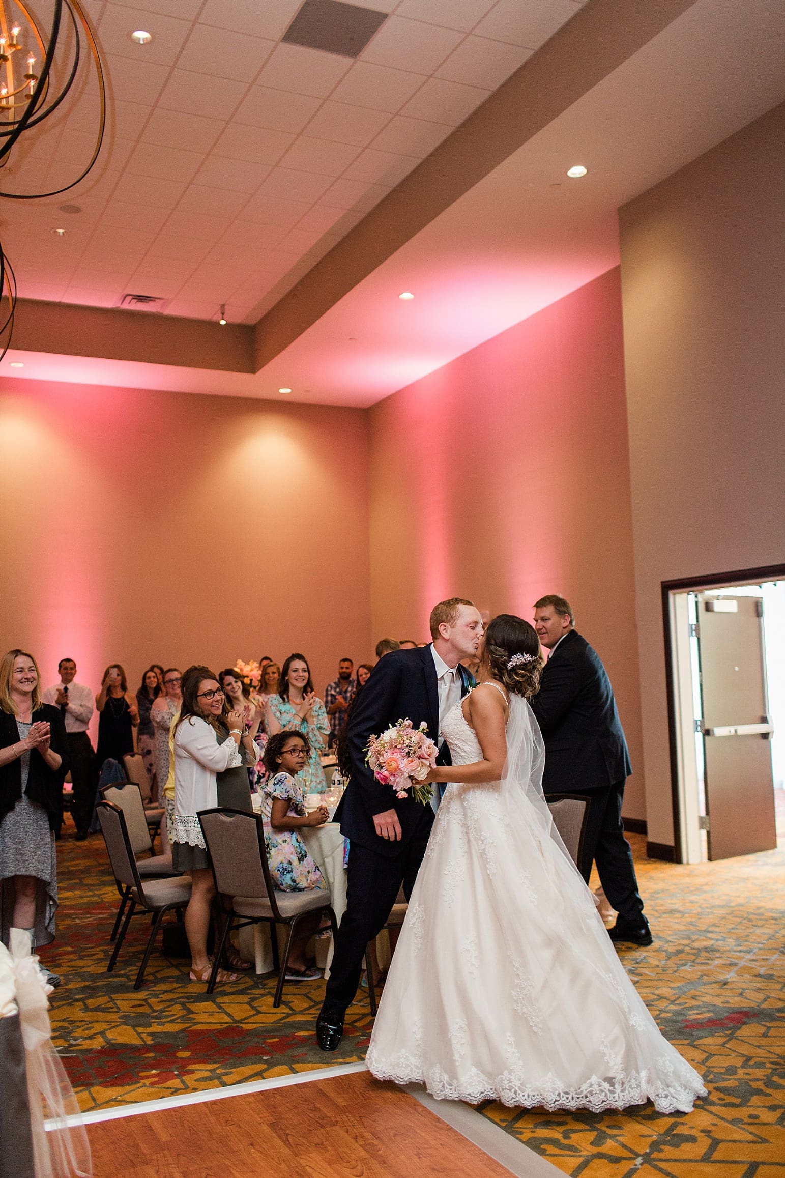 Arielle Peters Photography | Bride and groom entering wedding reception on wedding day at the Holiday Inn in Mishawaka, Indiana.