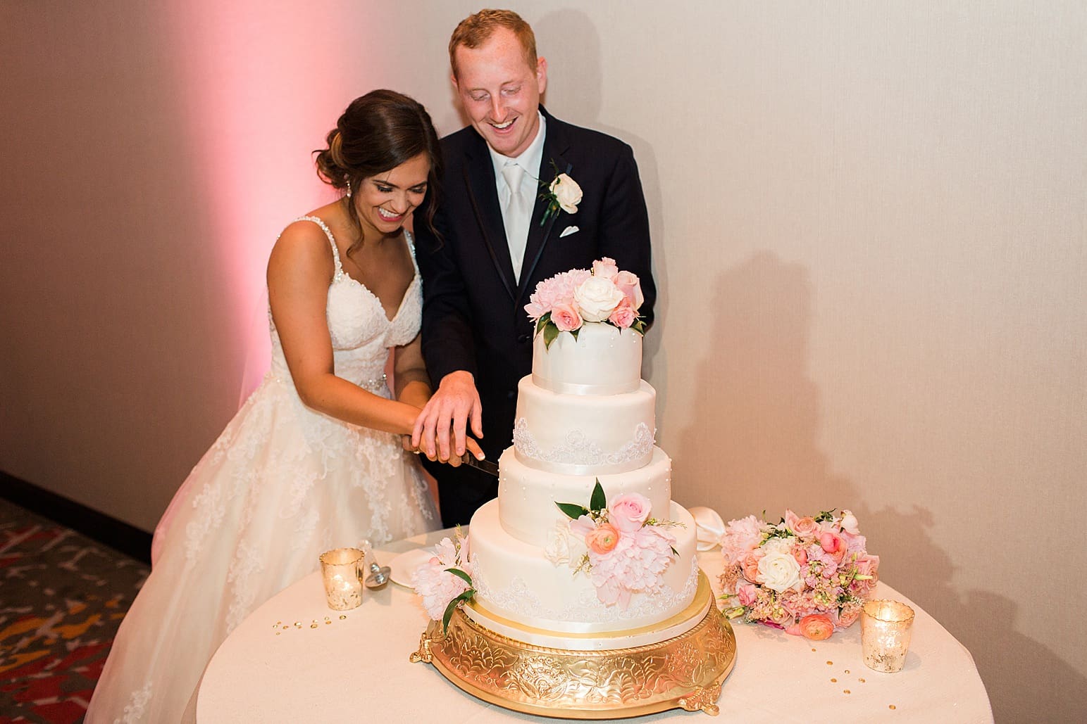 Arielle Peters Photography | Bride and groom cutting their wedding cake at wedding reception at the Holiday Inn in Mishawaka, Indiana.