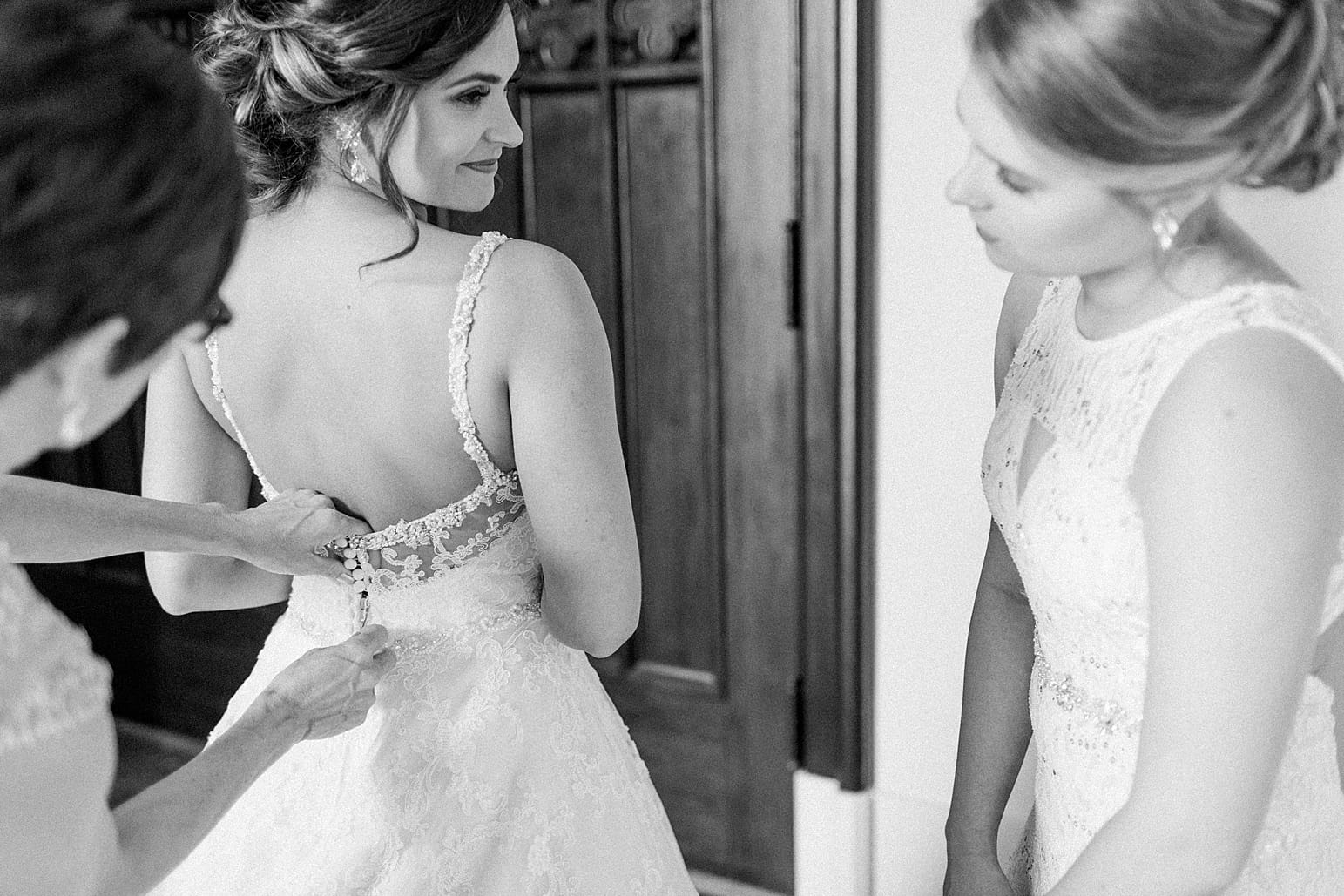 Arielle Peters Photography | Mother of the bride helping bride put on wedding dress on wedding day at First United Methodist Church in Mishawaka, Indiana.