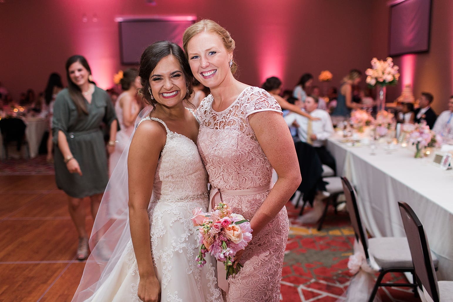 Arielle Peters Photography | Bride and bridesmaid together at wedding reception at the Holiday Inn in Mishawaka, Indiana.