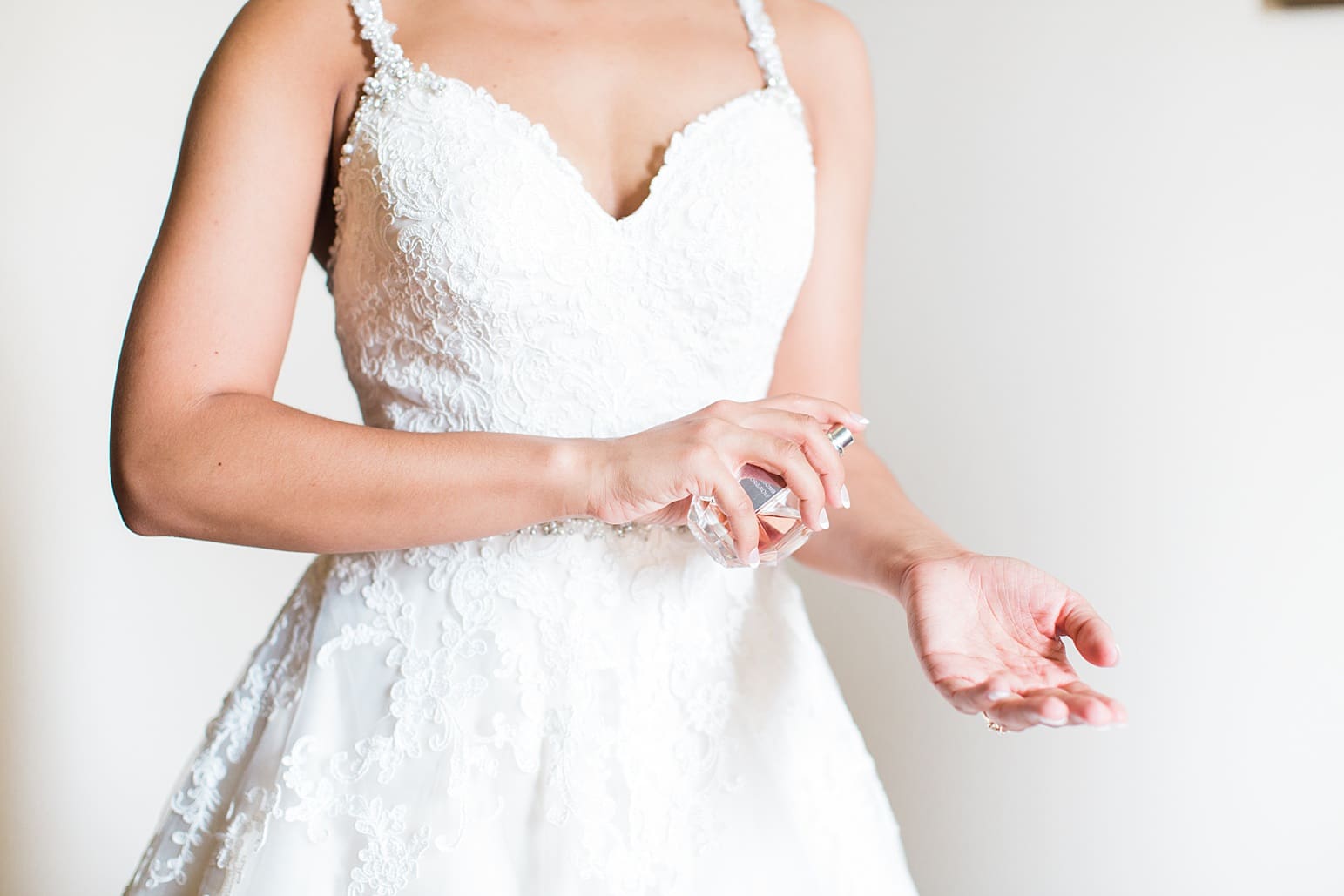 Arielle Peters Photography | Bride putting on perfume on wedding day at First United Methodist Church in Mishawaka, Indiana.