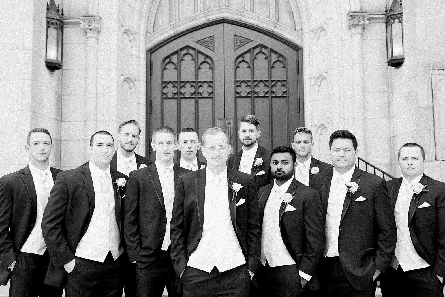 Arielle Peters Photography | Groom and groomsmen outside large cathedral church on wedding day at First United Methodist Church in Mishawaka, Indiana.