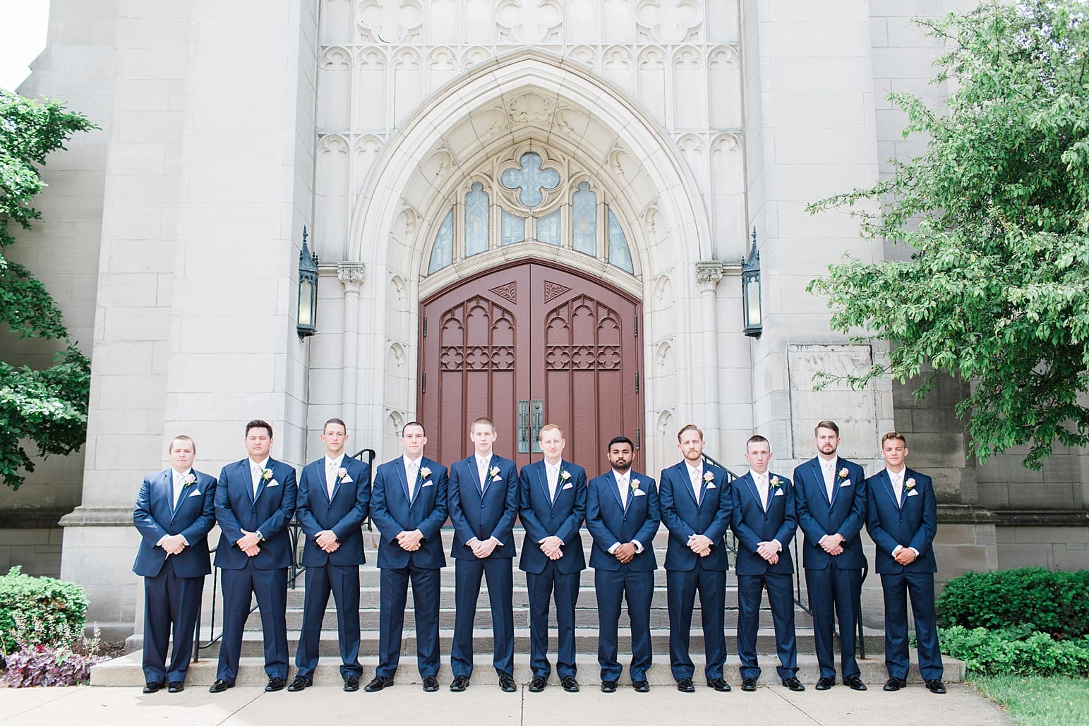 Arielle Peters Photography | Groom and groomsmen outside large cathedral church on wedding day at First United Methodist Church in Mishawaka, Indiana.