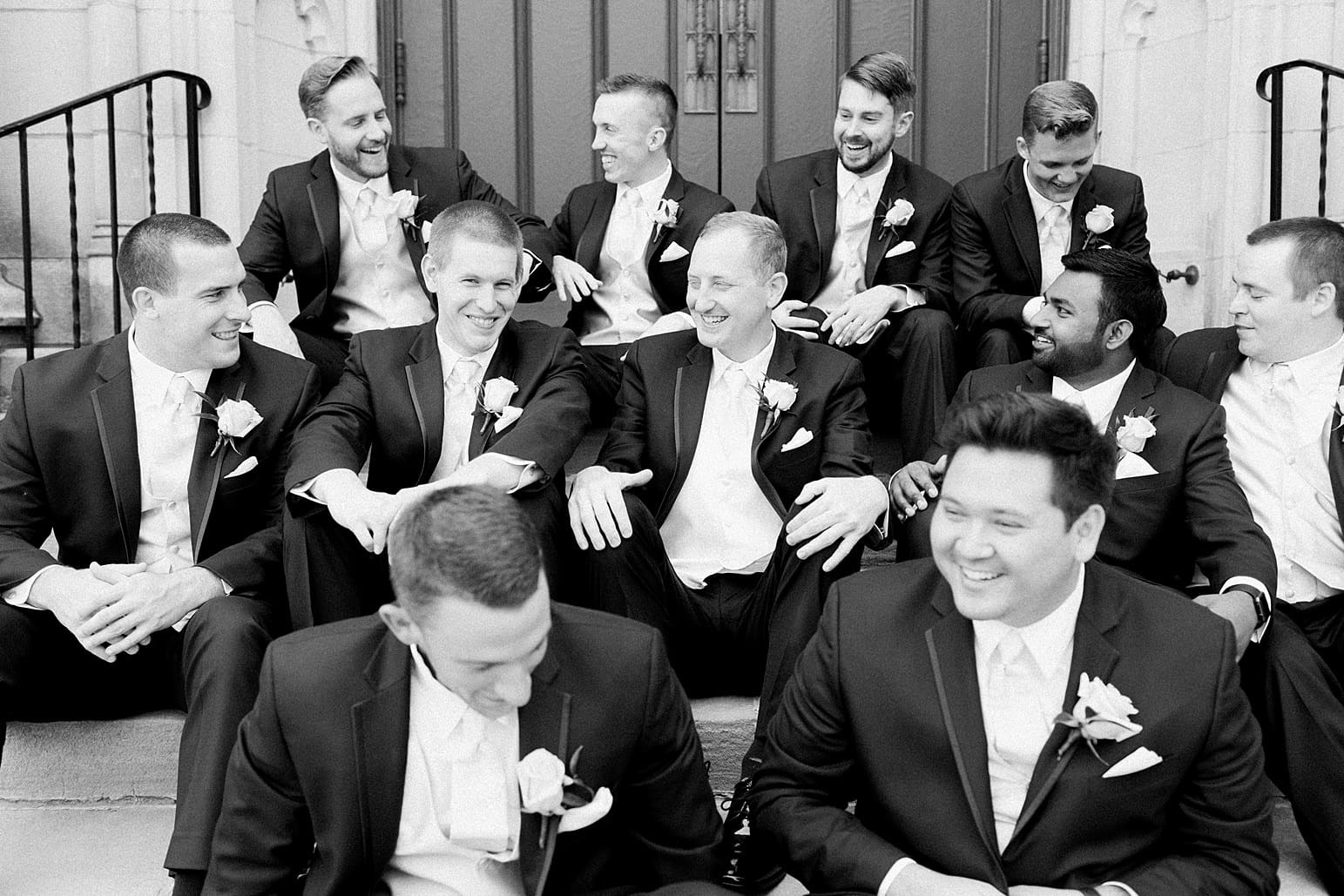 Arielle Peters Photography | Groom and groomsmen sitting on cathedral church steps on wedding day at First United Methodist Church in Mishawaka, Indiana.