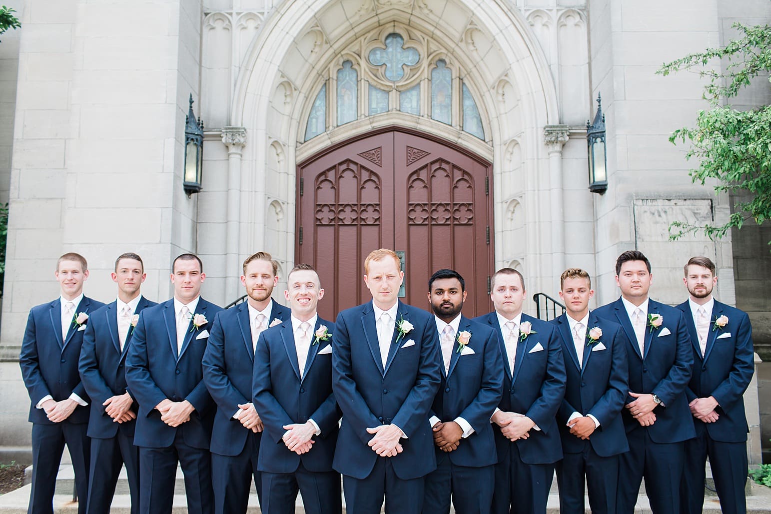 Arielle Peters Photography | Groom and groomsmen outside large cathedral church on wedding day at First United Methodist Church in Mishawaka, Indiana.