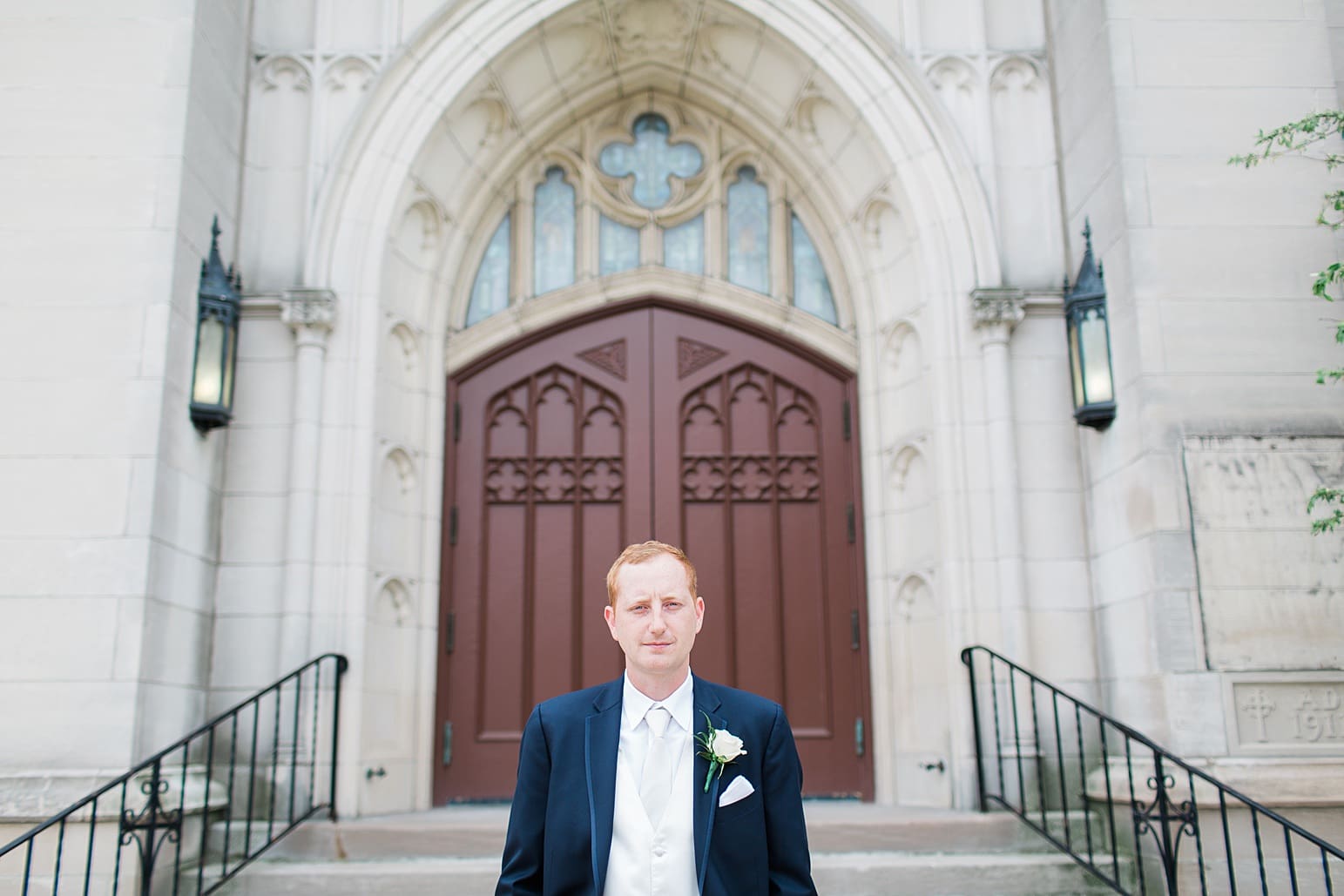 Arielle Peters Photography | Groom standing outside large cathedral church on wedding day at First United Methodist Church in Mishawaka, Indiana.