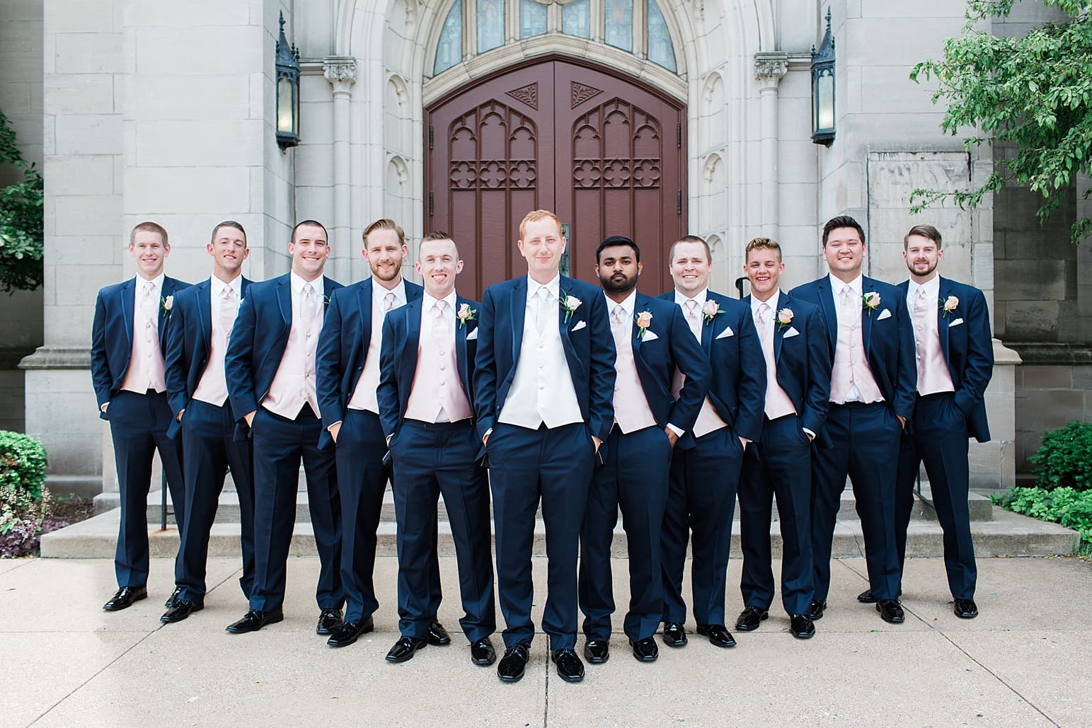 Arielle Peters Photography | Groom and groomsmen outside large cathedral church on wedding day at First United Methodist Church in Mishawaka, Indiana.