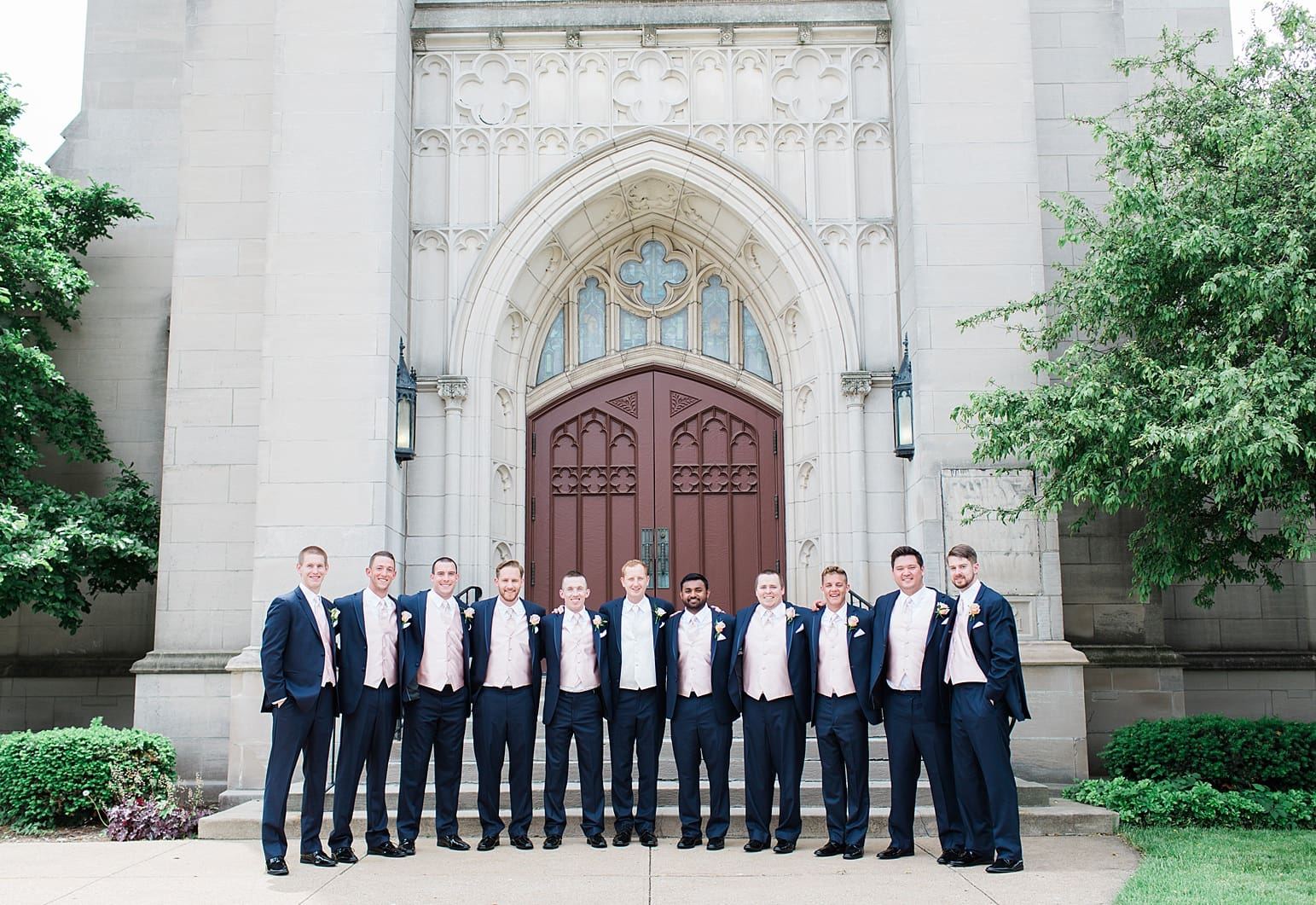 Arielle Peters Photography | Groom and groomsmen outside large cathedral church on wedding day at First United Methodist Church in Mishawaka, Indiana.