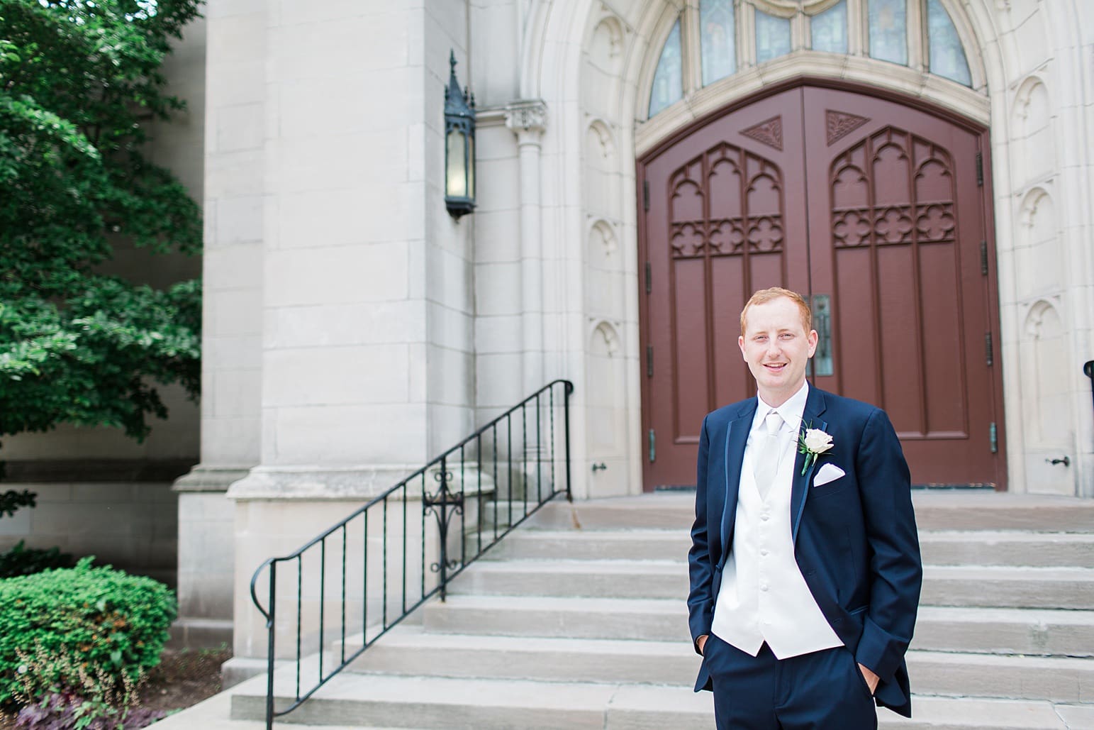 Arielle Peters Photography | Groom standing outside large cathedral church on wedding day at First United Methodist Church in Mishawaka, Indiana.