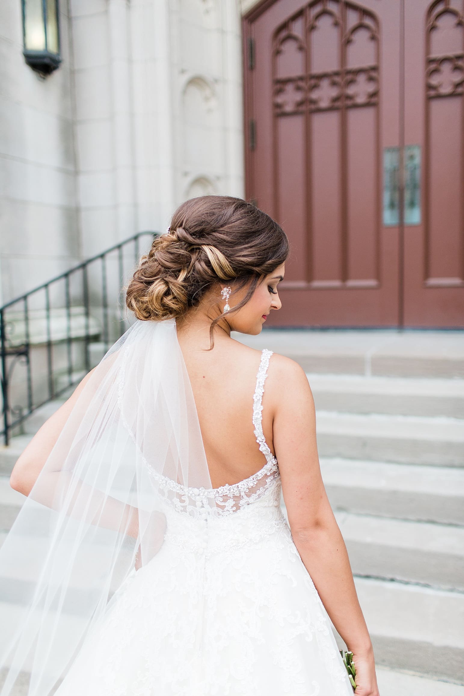 Arielle Peters Photography | Bride outside large cathedral church on wedding day at First United Methodist Church in Mishawaka, Indiana.