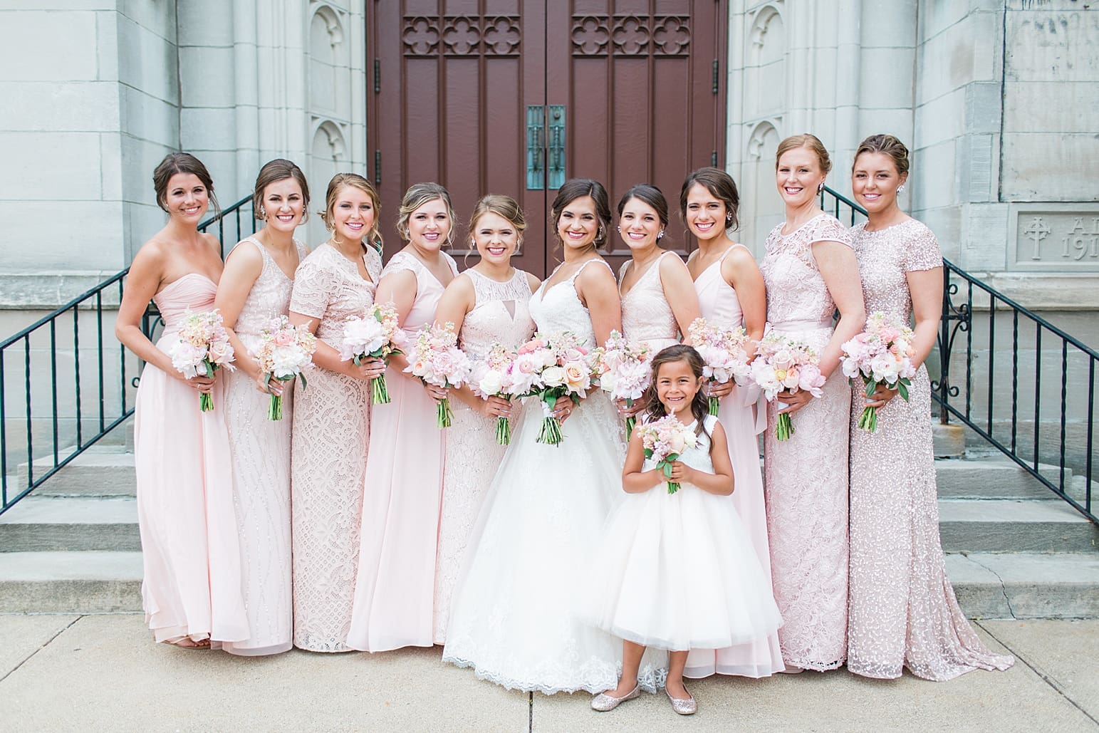 Arielle Peters Photography | Bride and bridesmaids outside large cathedral church on wedding day at First United Methodist Church in Mishawaka, Indiana.