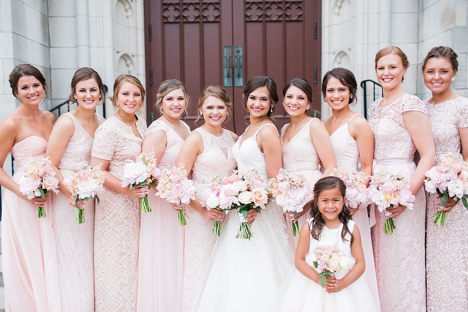 Arielle Peters Photography | Bride and bridesmaids outside large cathedral church on wedding day at First United Methodist Church in Mishawaka, Indiana.
