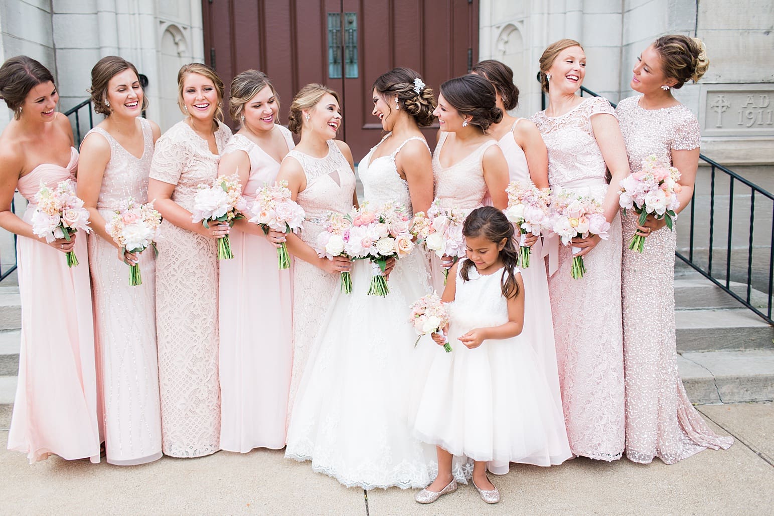Arielle Peters Photography | Bride and bridesmaids outside large cathedral church on wedding day at First United Methodist Church in Mishawaka, Indiana.